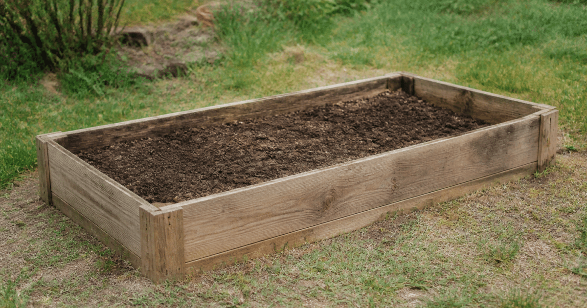 Bac de jardinage rectangulaire en bois rempli de terre brune
